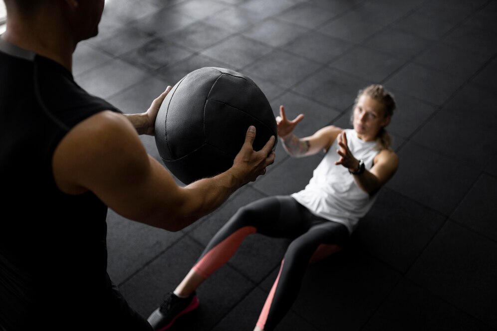 Personal training with a heavy ball.
source: Freepik.