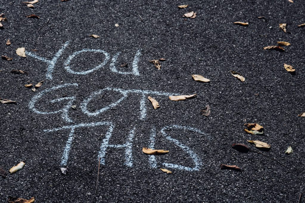“You got this” written on a road as a motivational insight for the people walking by.
