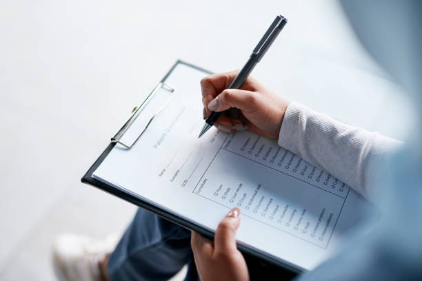 A woman filling out a survey form for gym members.