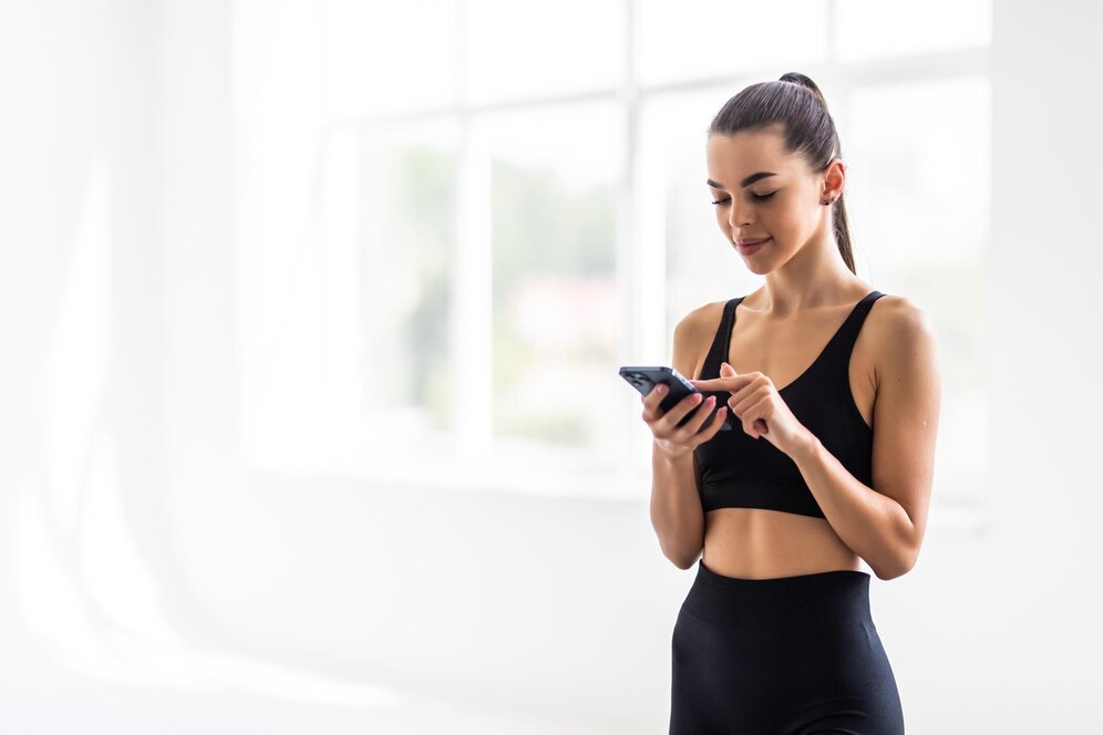 A young fitness woman happy to be on top of the leaderboard in her fitness app. 