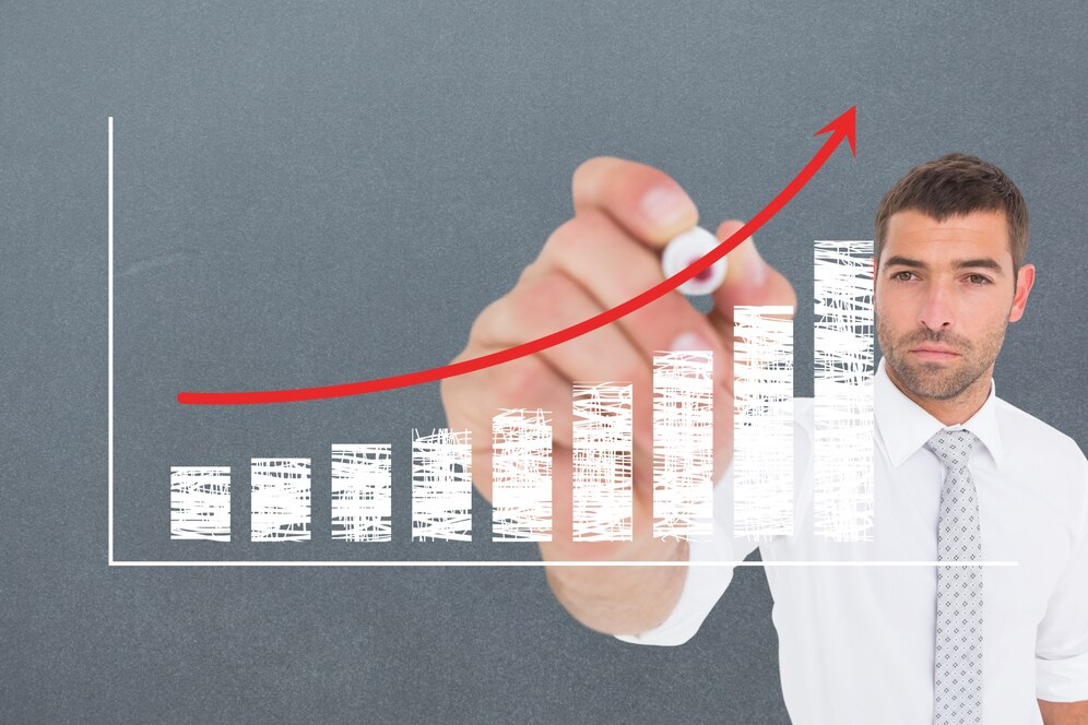 A man drawing income increase on fitness revenue graph.