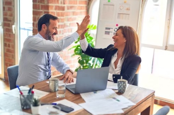 Business partners congratulating themselves after succeeding in the fitness industry.