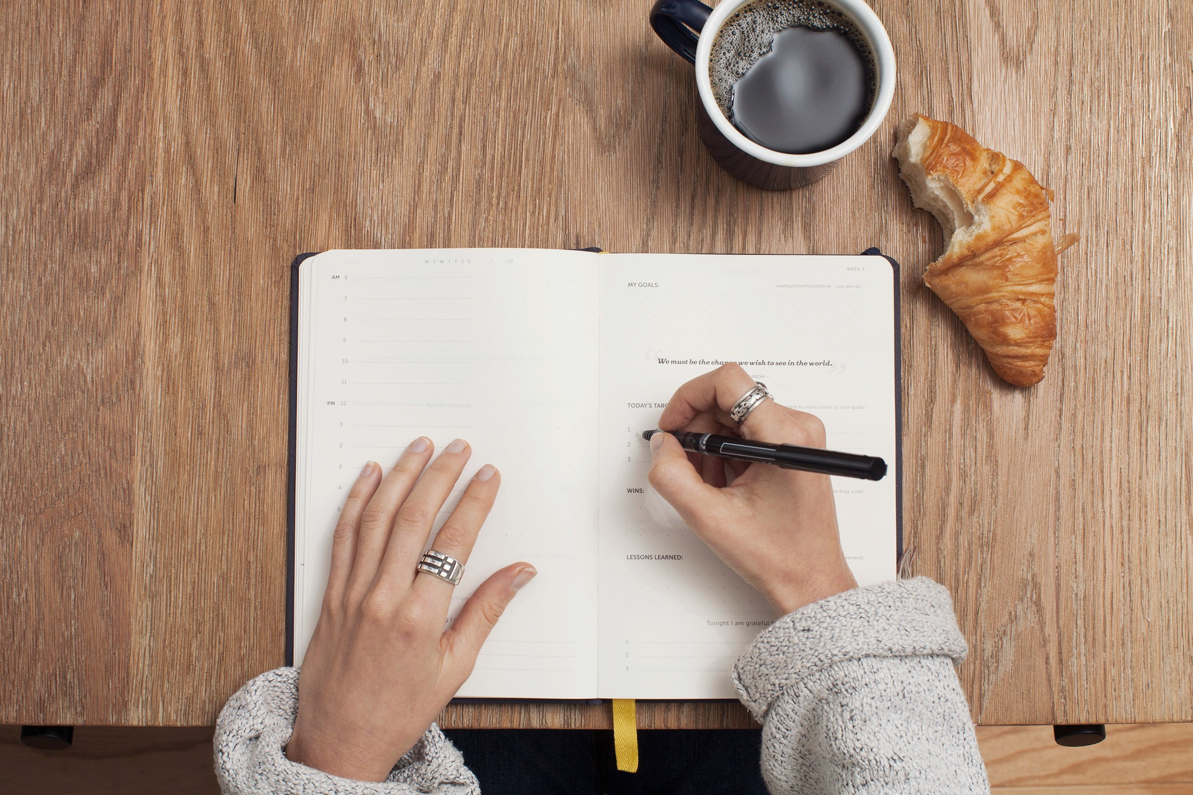 A coffee and croissant helpful for writing marketing strategies for the dance studio.