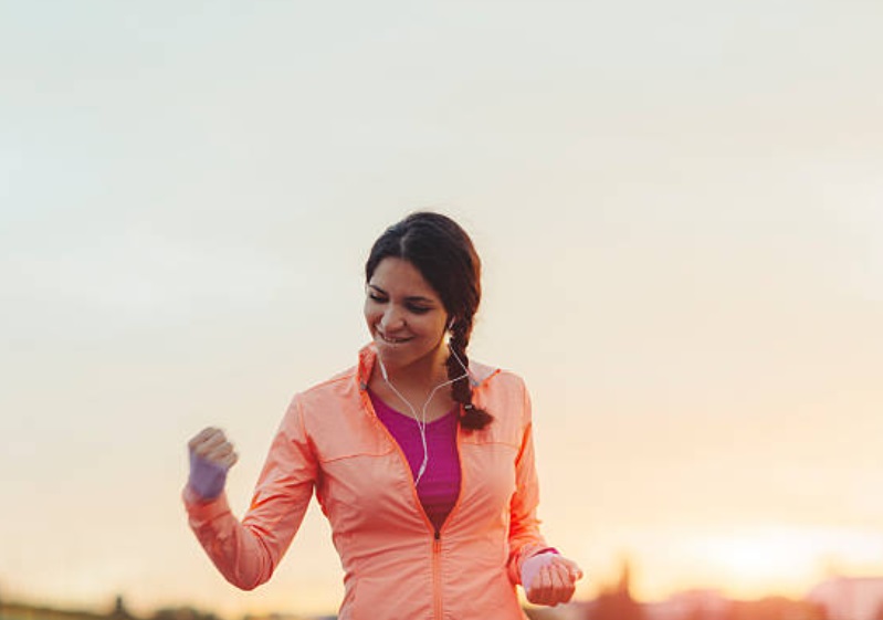 A happy woman who passed her exams and can become a fitness consultant.