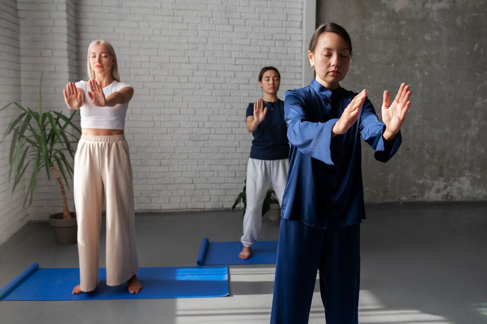 Three women practicing tai chi. Source: Freepik