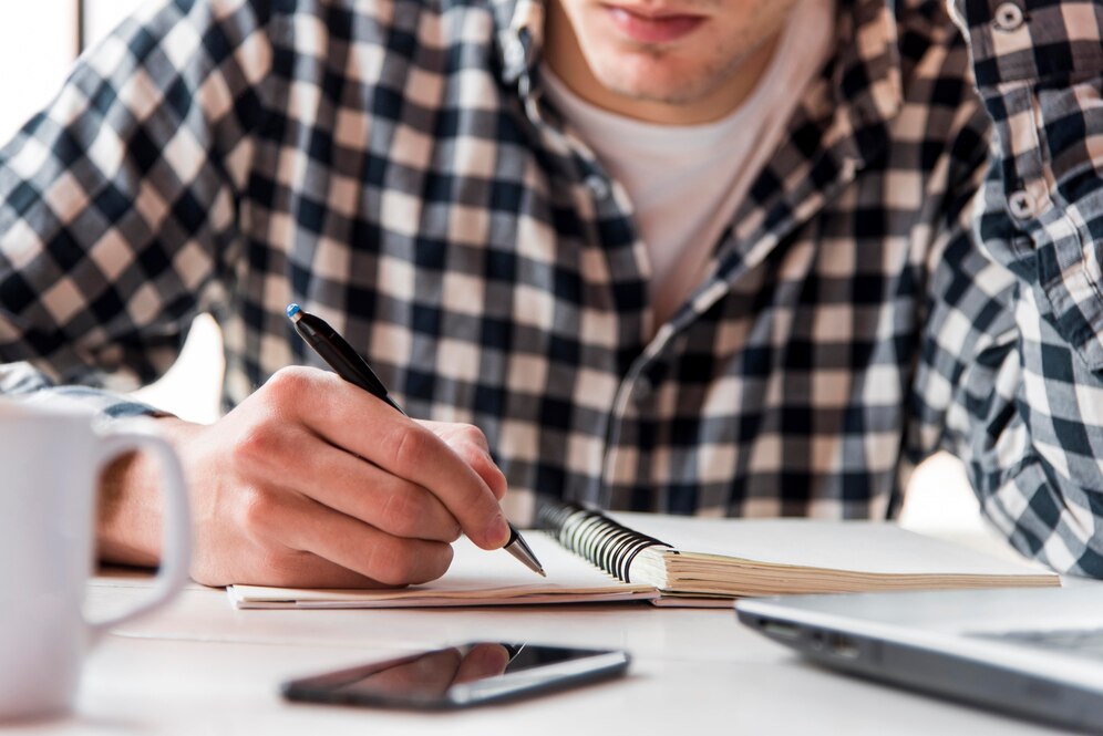 A man writing a gym business plan.