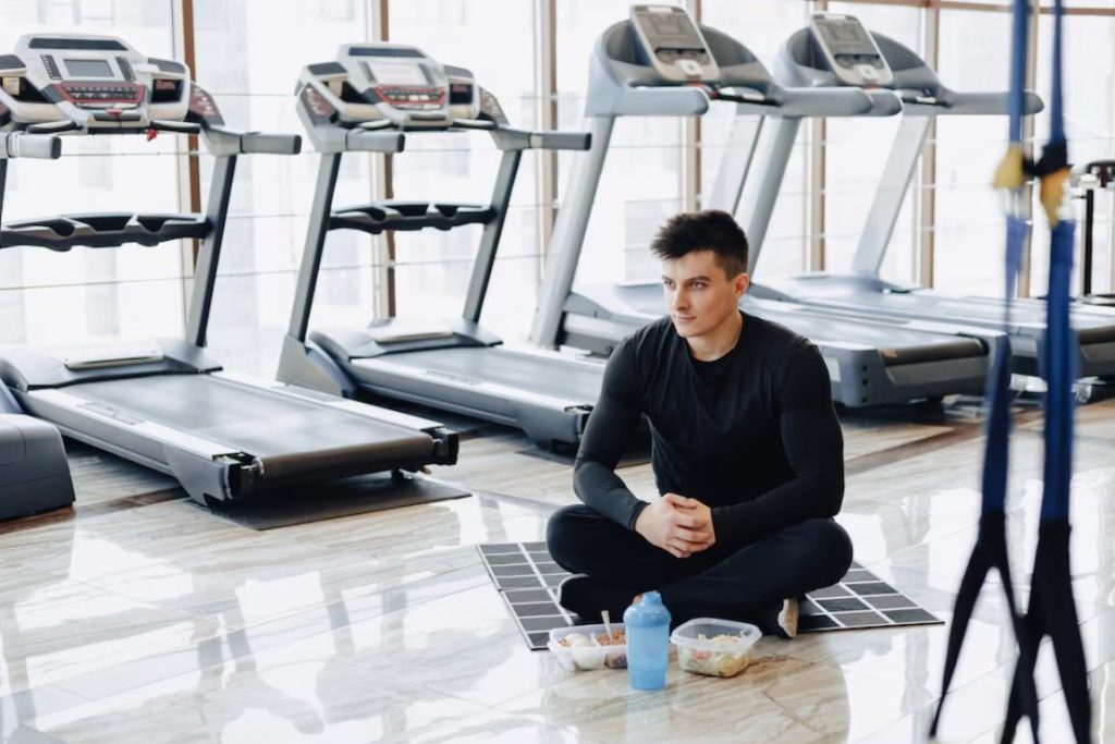 A gym owner having breakfast in his empty gym.