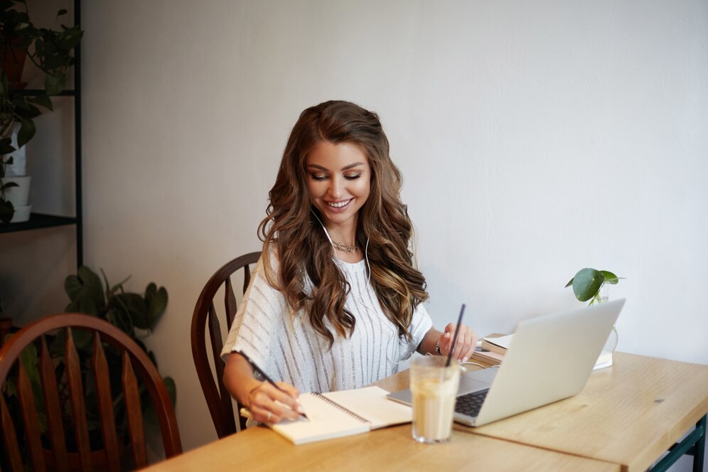 A woman writing her gym business plan