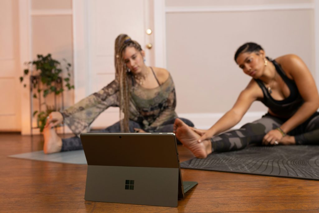 Two women practicing with an online instructor. Offering remote meetings can be your studio’s advantage.