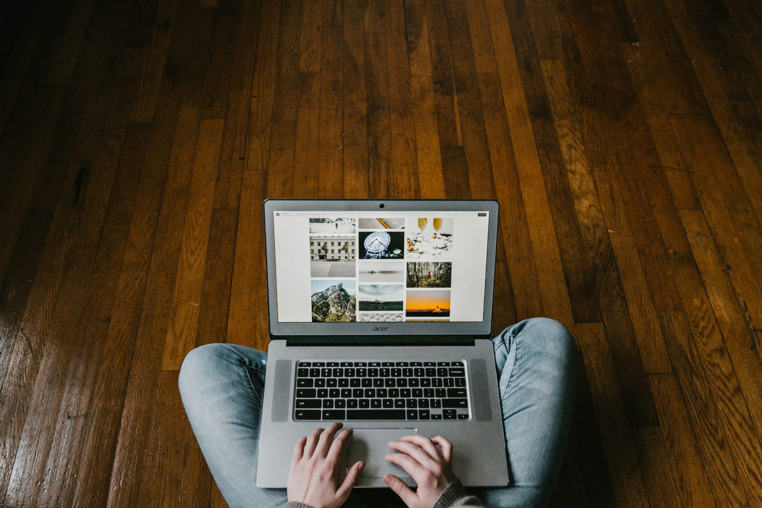 A dance studio owner writing a business plan on a PC, sitting on his dancefloor.