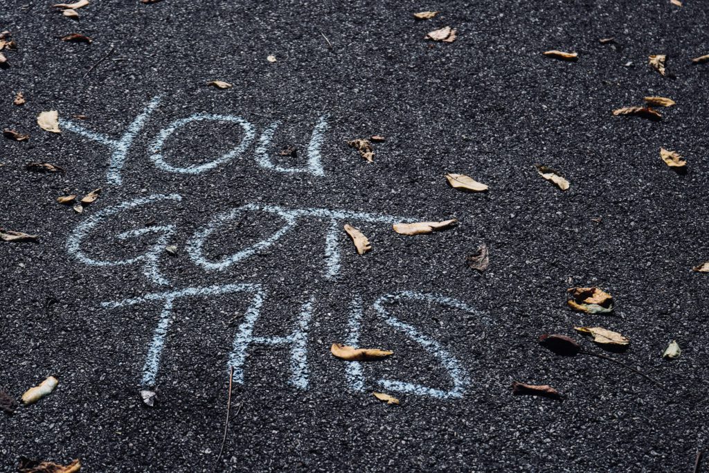 “You got this” written on a road as a motivational insight for the people walking by. 