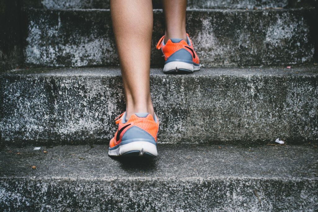 A gym goer on stone stairs.