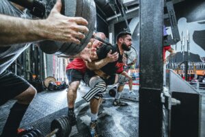 A weightlifter protected by his trainer.