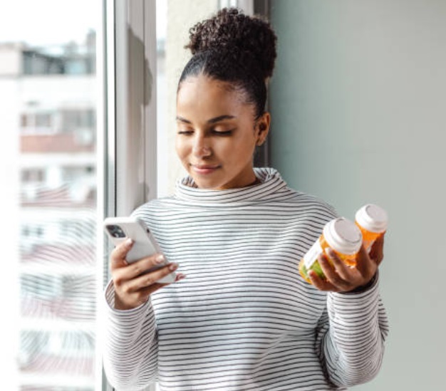 A woman checking her gym app.