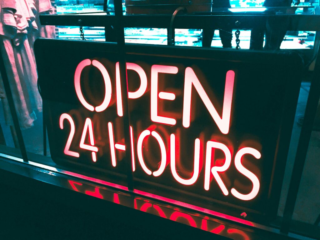 A neon sign informing about a convenient 24 hour gym access.