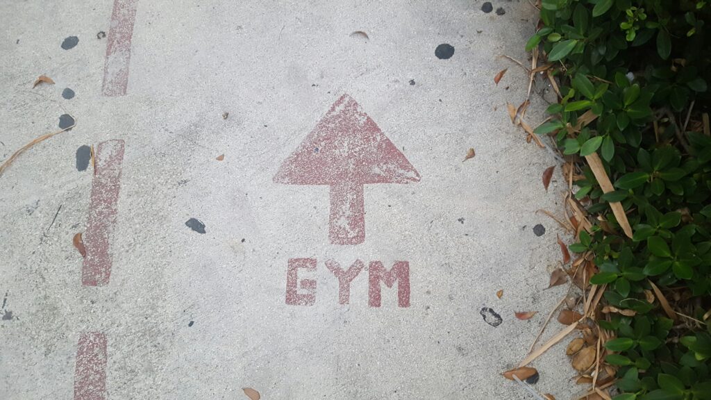 Gym sign on the pavement.