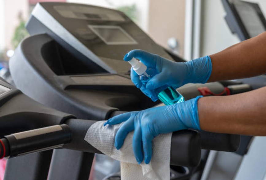 Exercise equipment surfaces in the fitness center should be wiped with a cleaning solution.