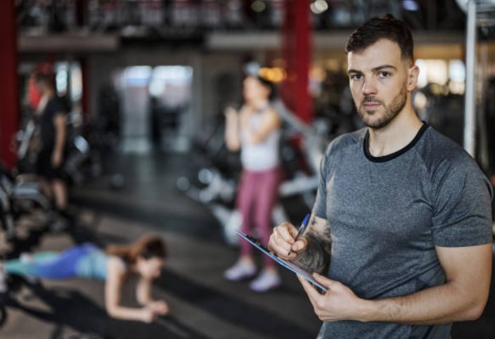 A personal trainer using a template of his workout programs.