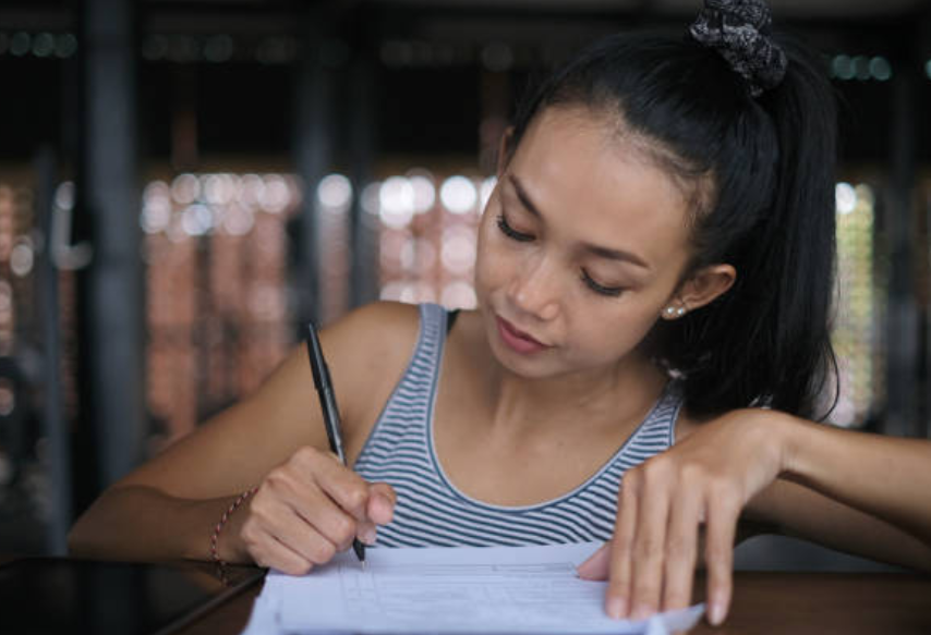 A woman filling in a gym registration form.