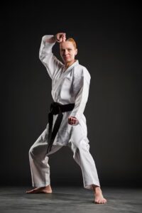 A woman in a karate pose.
Source: Freepik