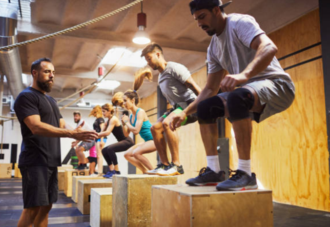A crossfit trainer with their clients during a training session.