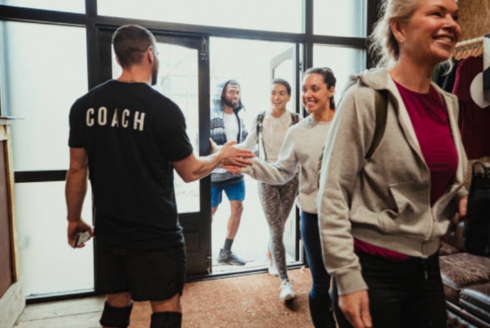A crossfit coach may be a personal trainer or may conduct group classes, like here.
