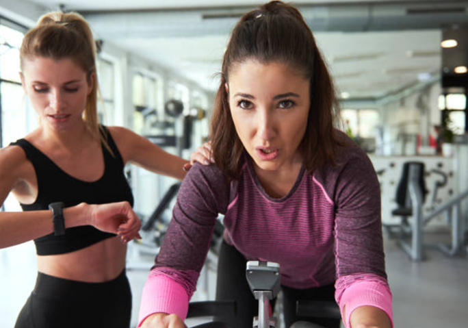 Fitness enthusiasts who agreed to workout with a spin instructor, have a tough but effective workout.