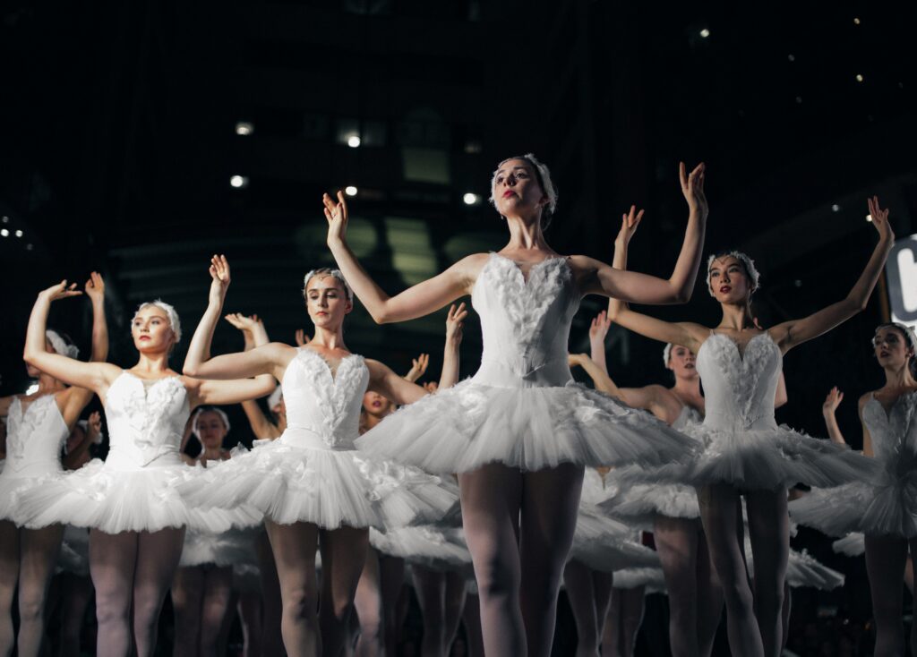 Ballet dance instructor with her students during a dance show.