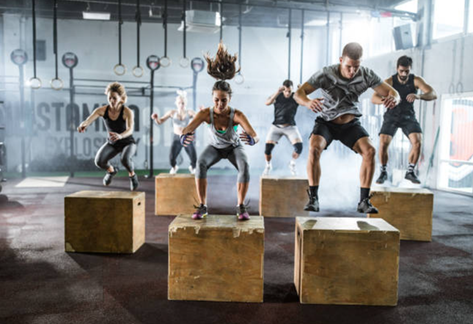 CrossFit gym with raw design elements, like wooden equipment, highlighting the discipline values of strength training.