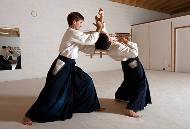Aikido dojo: a student and a teacher fighting.