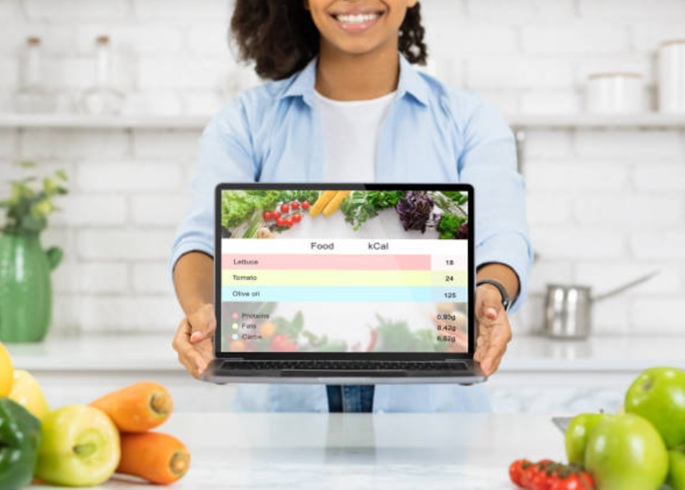 Nutritionist in her private practice, showing meal plans on the screen of a nutrition coaching app.